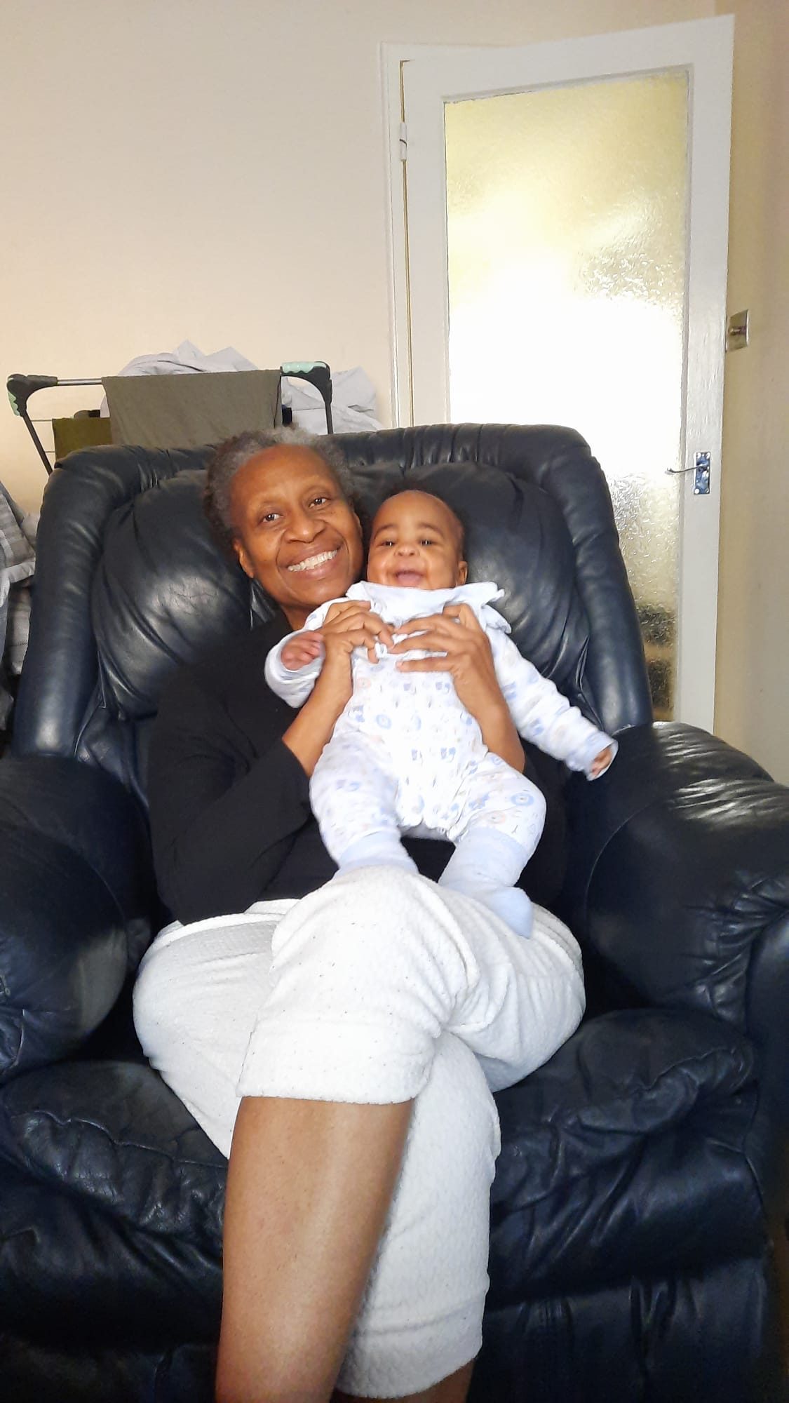 Holding her grandchild.